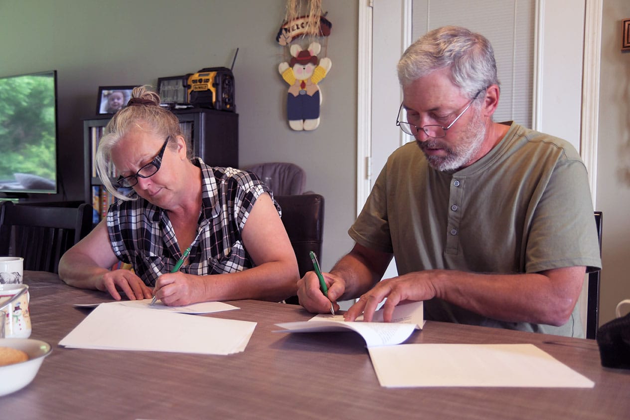 Angela and Tony Prynne sign DUC Conservation Agreement on their farm near McAuley MB in July 2022 (photo DUC)