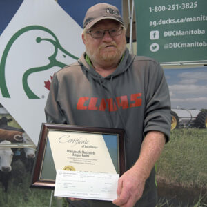 Gerald Wildfang accepting award for Top 5 Forage Establishment from Ducks Unlimited Canada.