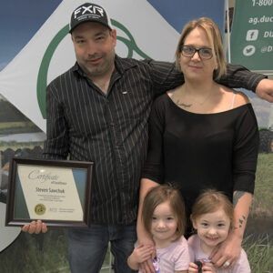 Steven Sawchuk and family accepting award for Top 5 Forage Establishment from Ducks Unlimited Canada.